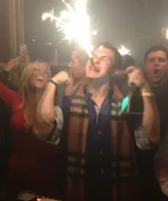 Johnny Manziel partying at a club and holding a bottle of Dom Perignon