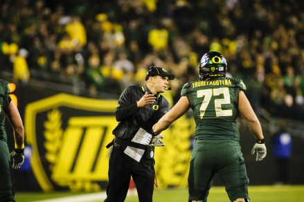 Photo: Craig Stroebeck Coach Helfrich asks Andre exactly how to pronounce his name.
