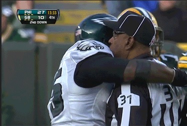 Vinny Curry shares a tender moment after ripping Tolzein's helmet off.