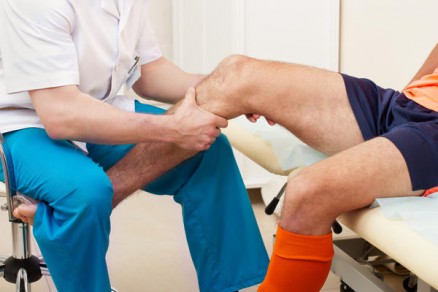 Doctor examining a patient complaining of knee pain.