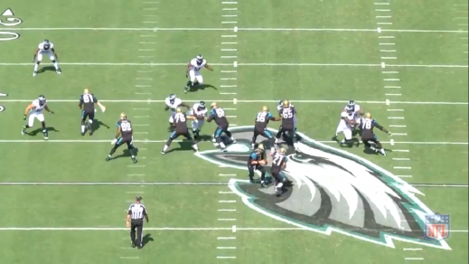 Cox attacks the left guard, while Logan (#96) loops around the left tackle. 