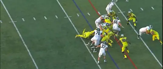 Oregon makes the gang tackle because the gaps are sealed off and the running back has nowhere to run. 