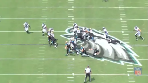 Cox uses a bull-rush to close in on Jacksonville running back Toby Gerhart.