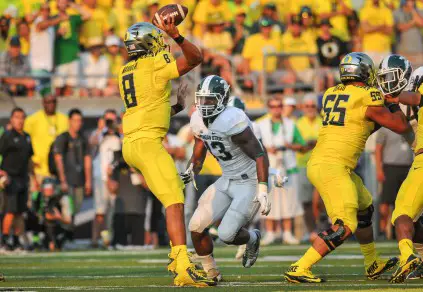 Despite heavy pressure Marcus Mariota led the Ducks offense with 3 TD's against Michigan State.