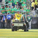 Andre Yruretagoynea (72) carted off due to lower leg injury in Michigan State game.