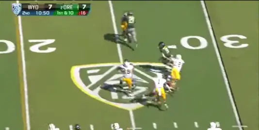 Grasu's block disrupts the defender's timing and throws him off course, causing him to whiff while trying to tackle running back Byron Marshall. 