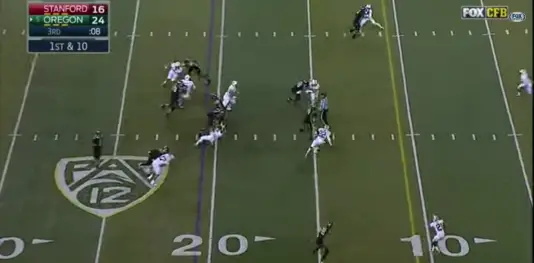 Grasu drives the linebacker backwards several yards, allowing Tyner to run free up the middle.