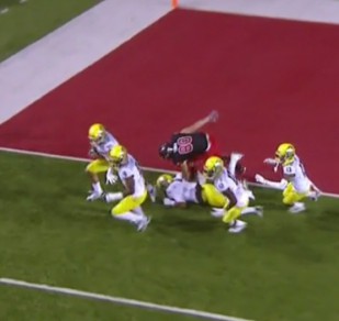 Joe Walker starts flying down-field accompanied by a mob of Ducks protecting him from Utes for 100 yards. 