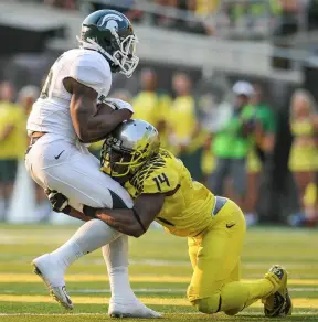 Ekpre-Olomu makes another tackle, vs. Michigan State.