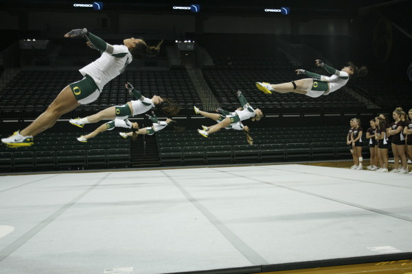 Flying through the air in team floor work.