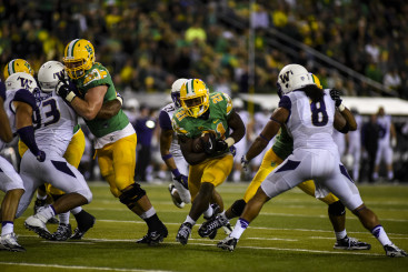Royce Freeman powers his way through the middle.