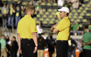 Coach Helfrich and Offensive Coordinator Scott Frost speaking together prior to the Oregon vs Washington game