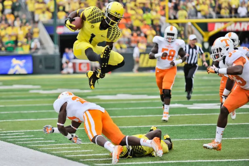 Josh Huff hurdles a defender against Tennessee in 2013.