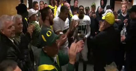 The team sings Mighty Oregon in the locker room after beating OSU