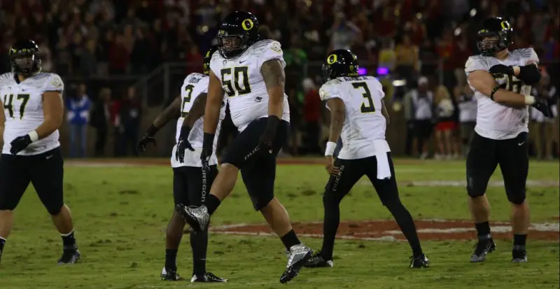 The Oregon offense celebrates a productive day in 38-36 win over Stanford.