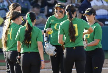 Oregon Ducks discuss strategy in a huddle.