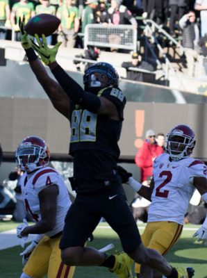This Duck (Dwayne Stanford) flies high for a TD over hapless Trojans.