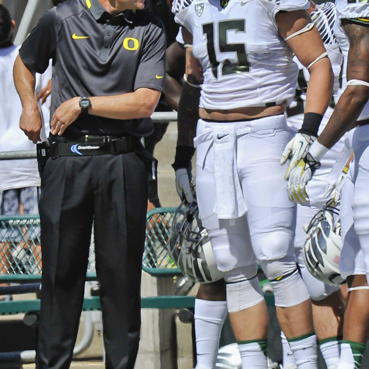 Chip Kelly teaches Michael Vick how to hold a football 