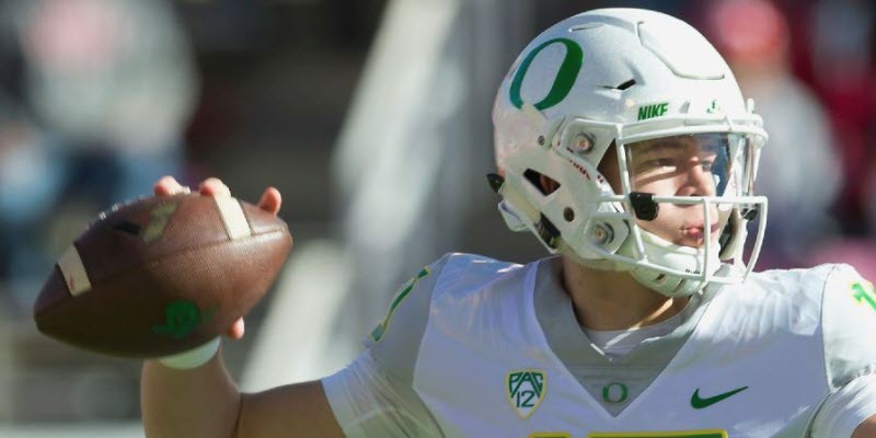 Justin Herbert of the Oregon Ducks passes the ball against the