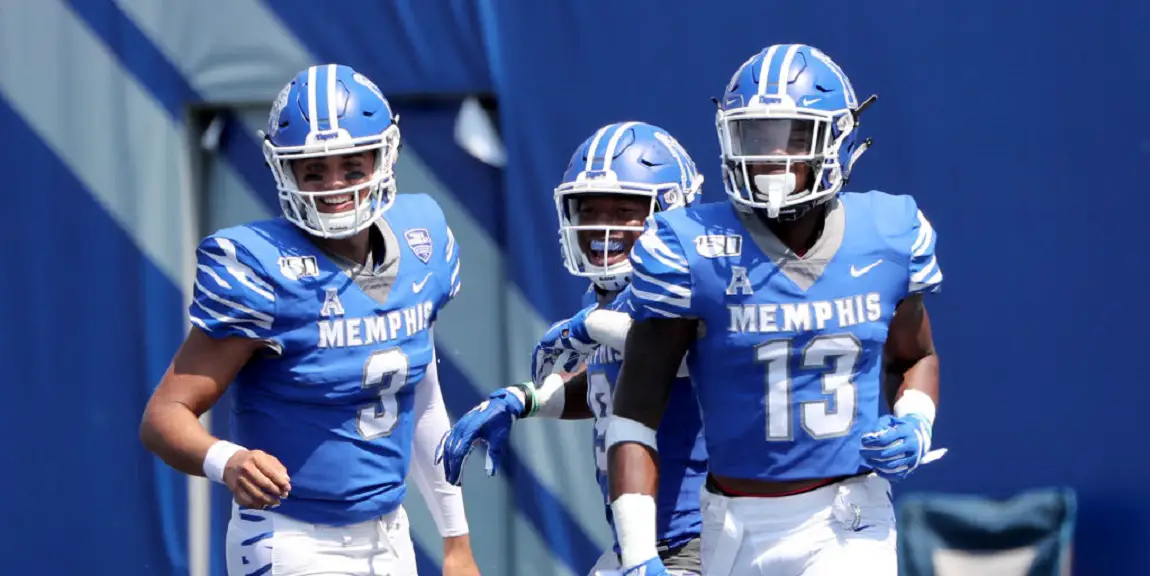 Image of three Memphis football players in blue jerseys.