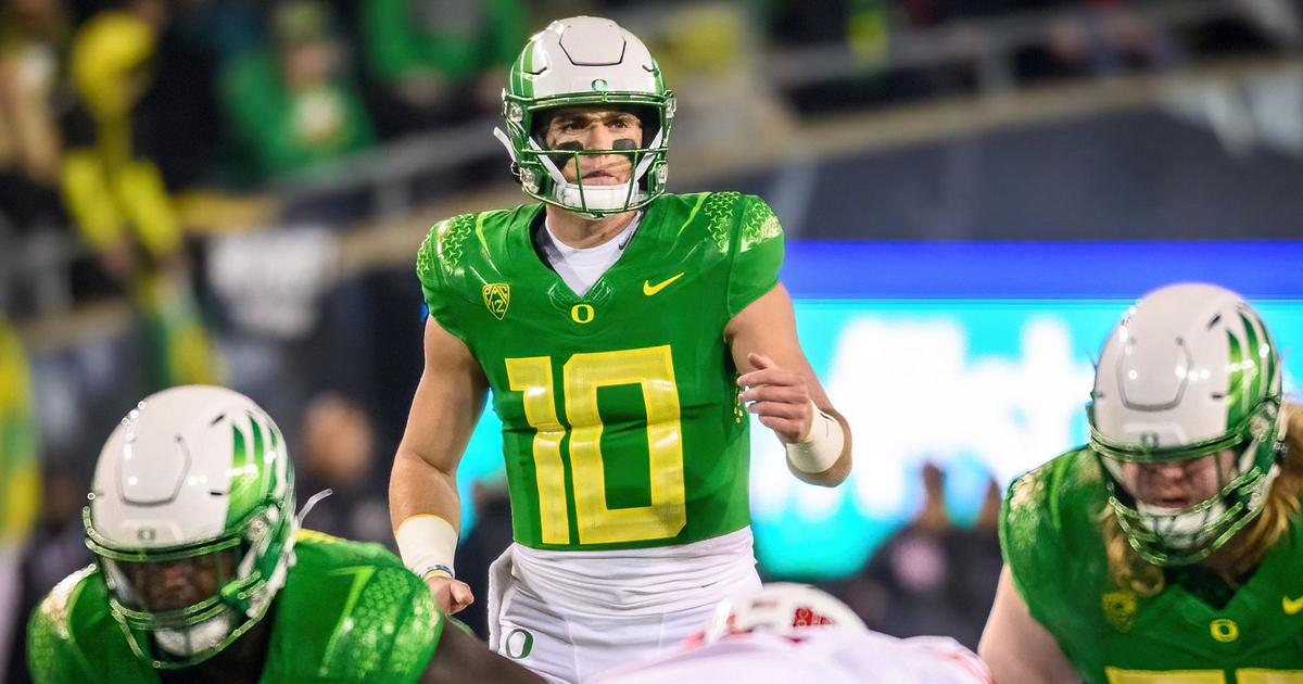 Justin Herbert Oregon Ducks Unsigned White Jersey Warming Up Photograph